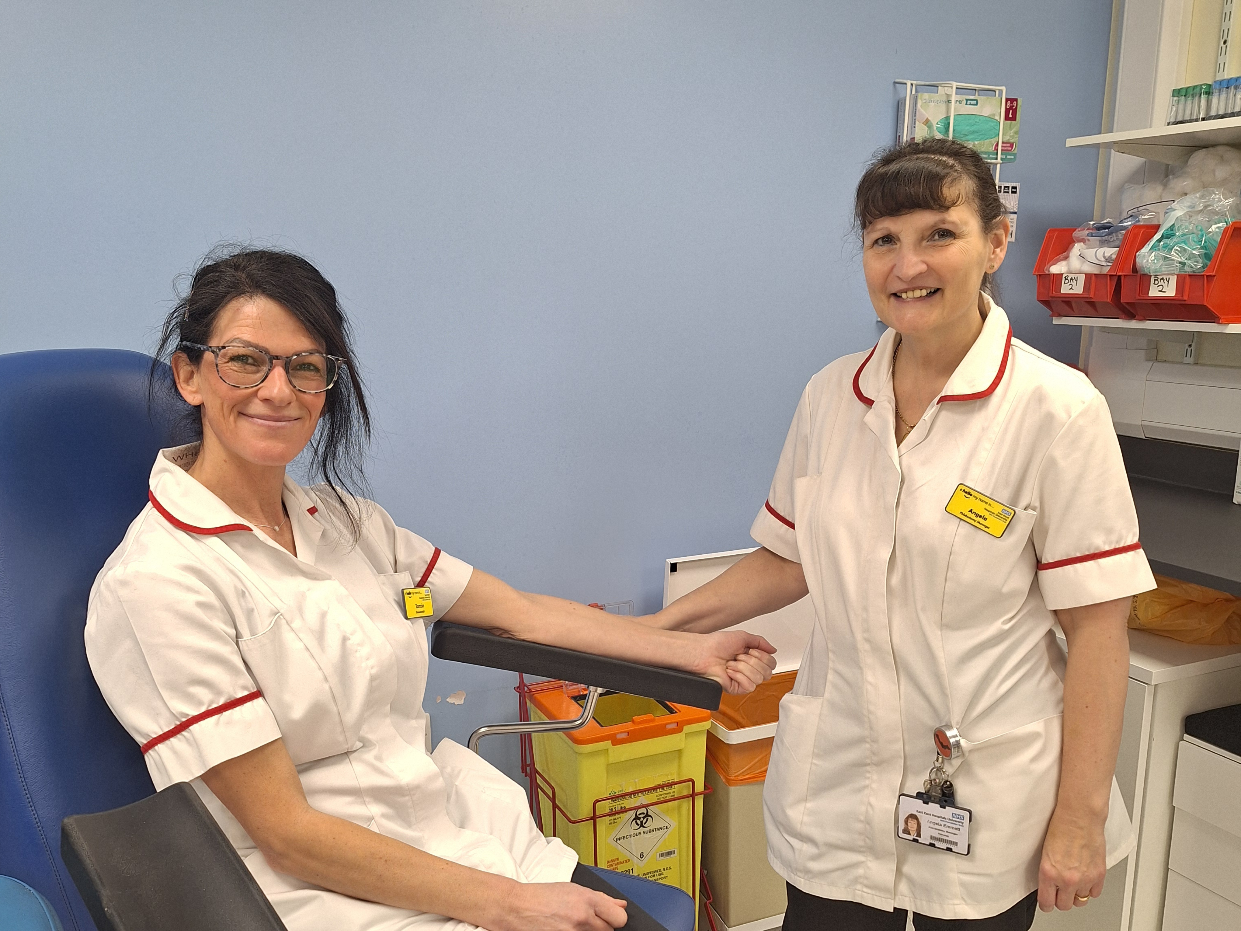 Angela Emmett, standing, with a colleague in the chair