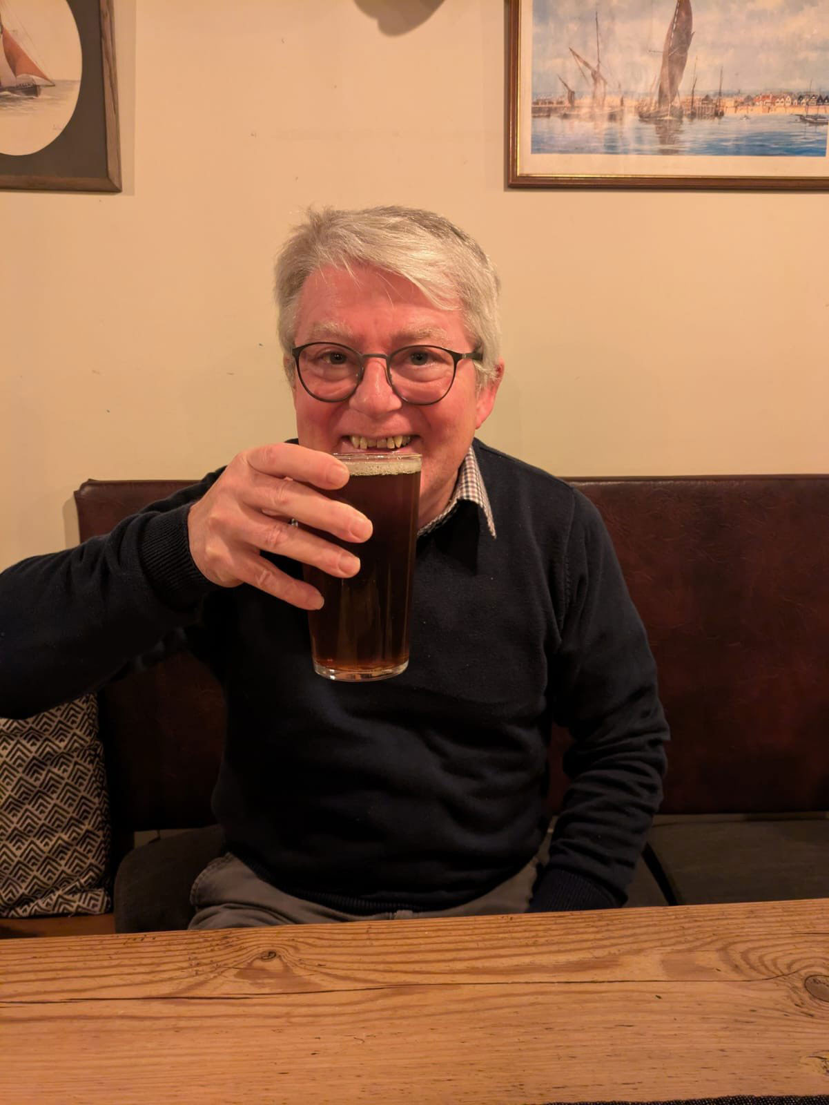 Barry raising a pint and smiling