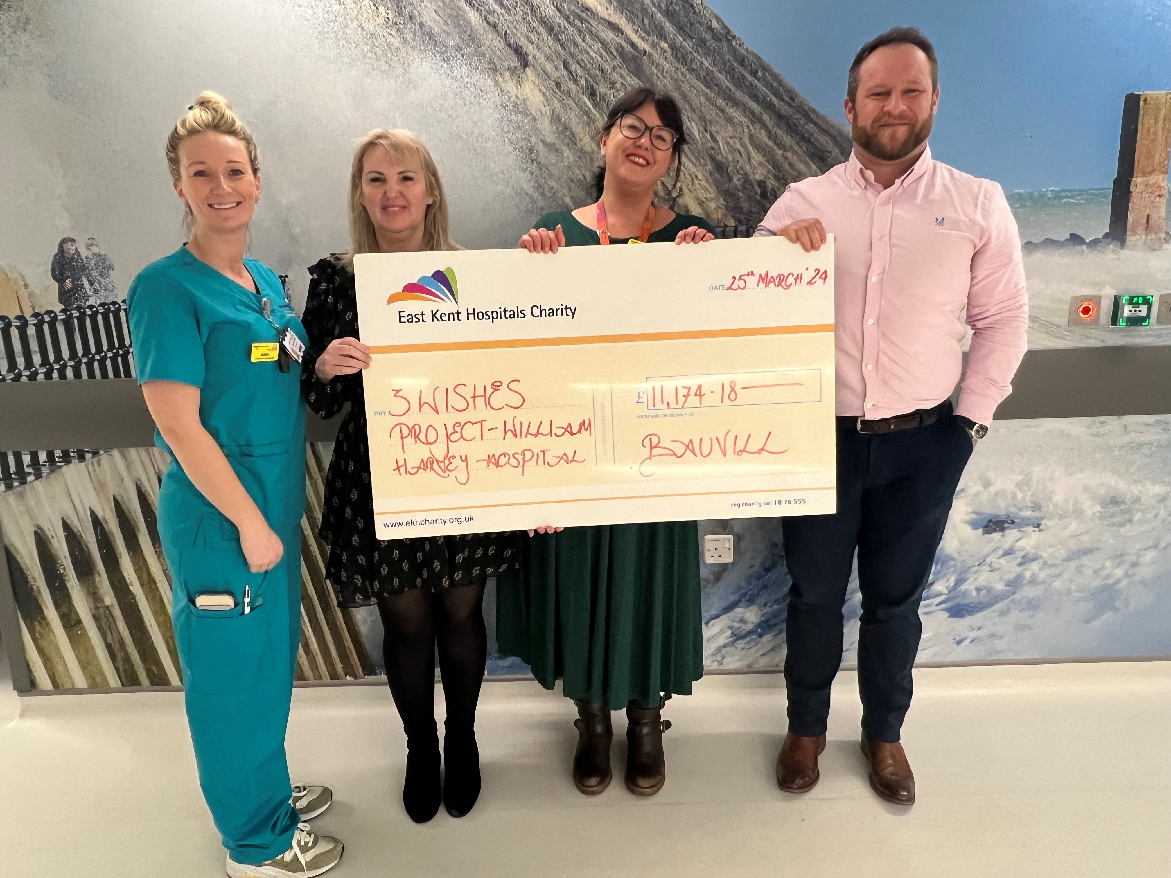 Critical care staff, Dee from the charity and Matt from Bauvill holding a big cheque for the 3 wishes project with £11,174.18 on it