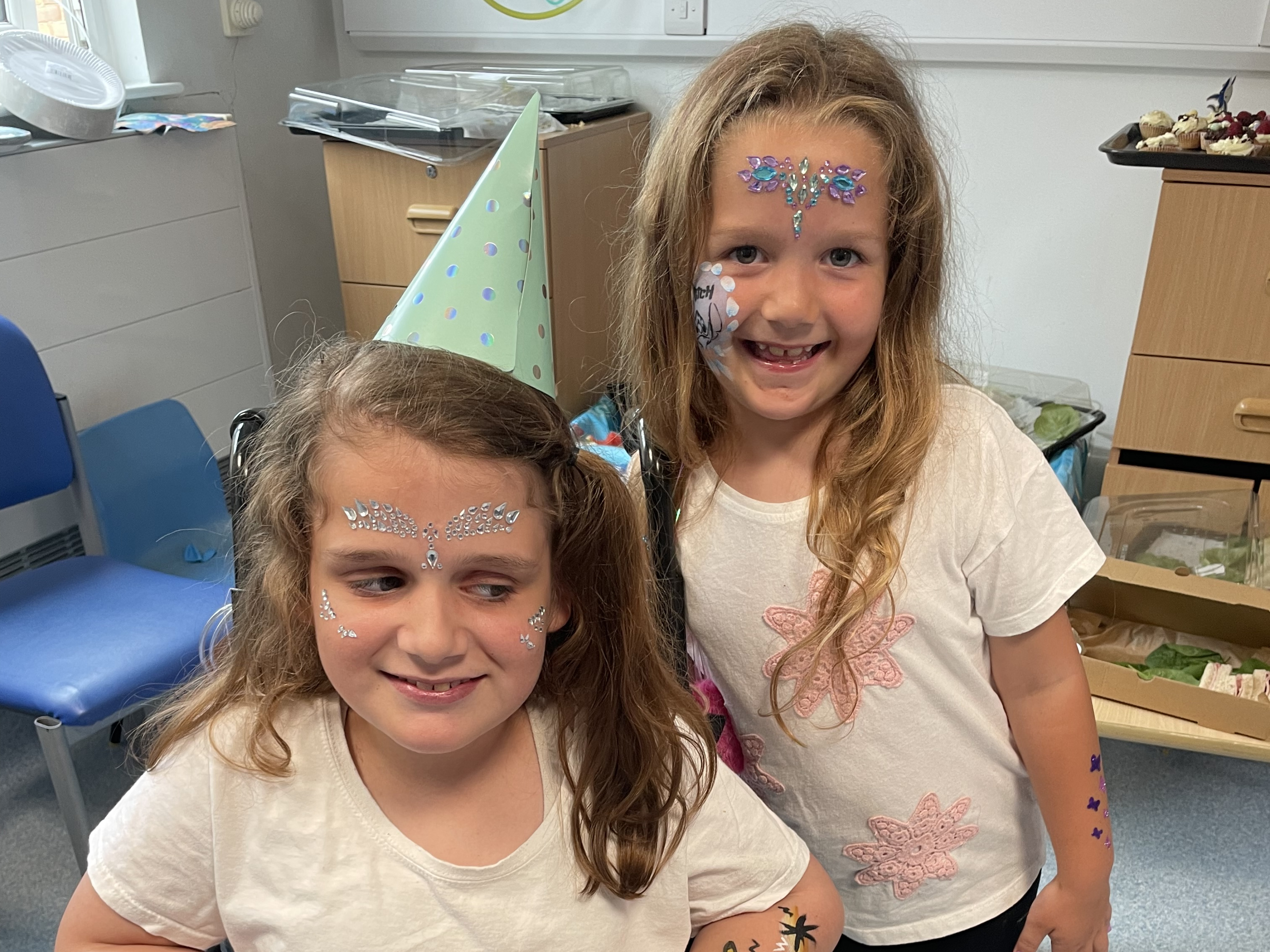 Hallie Robb, in a wheelchair, and her sister Isla at the party