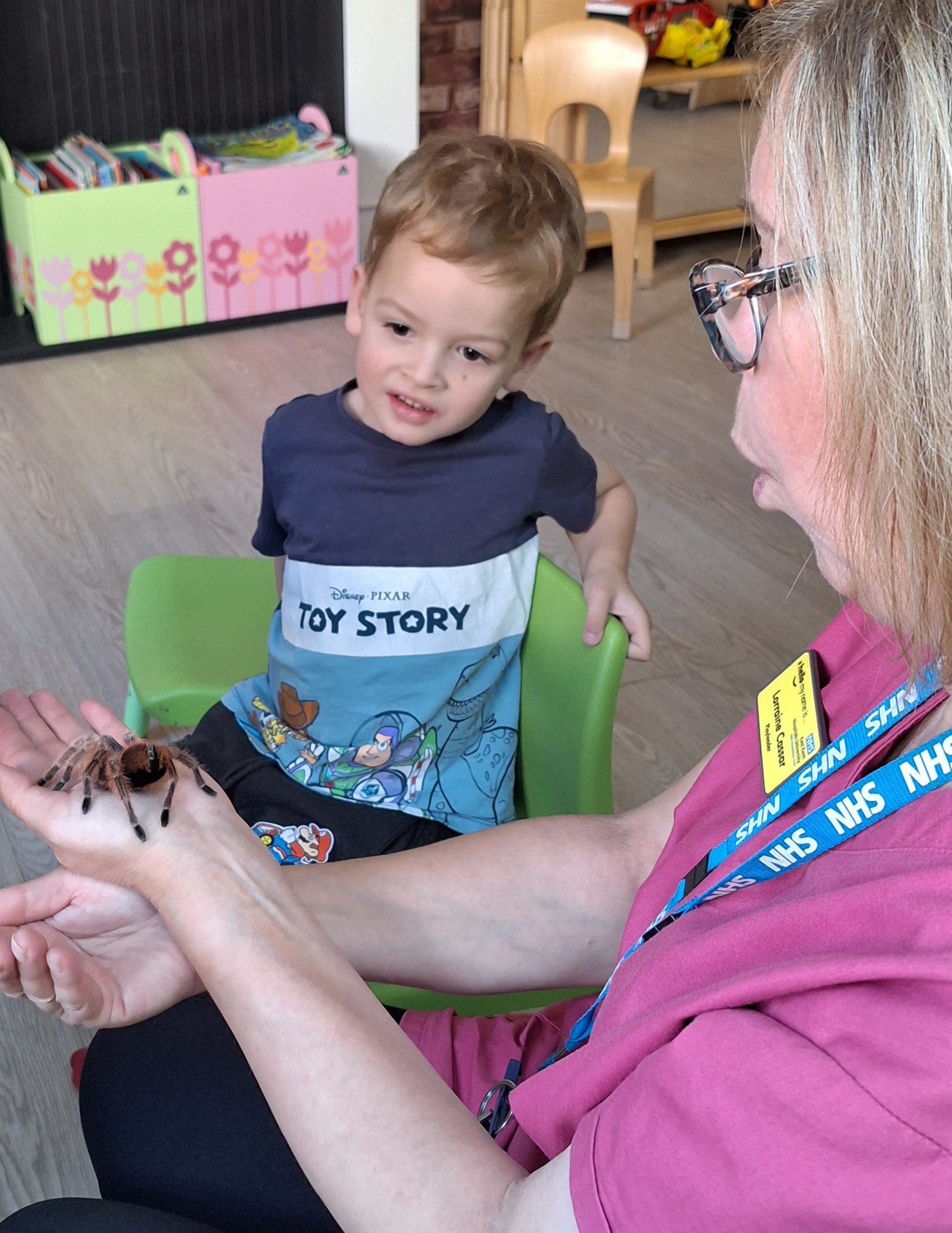 Jozef meets Poppy the tarantula, held by play leader Lorraine Cassar