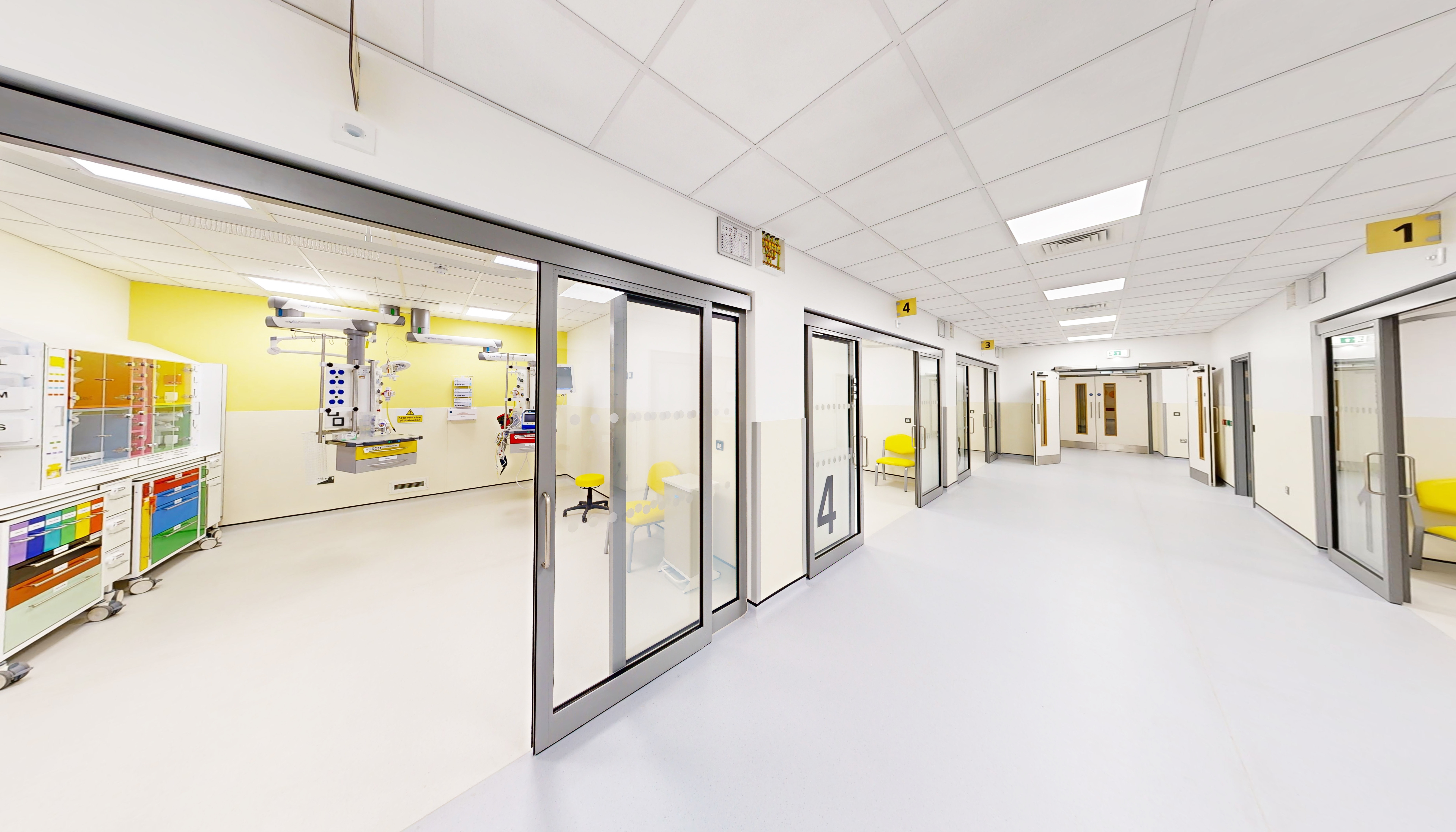 The new resuscitation area at the QEQM. Image shows a corridor with rooms off it with sliding doors