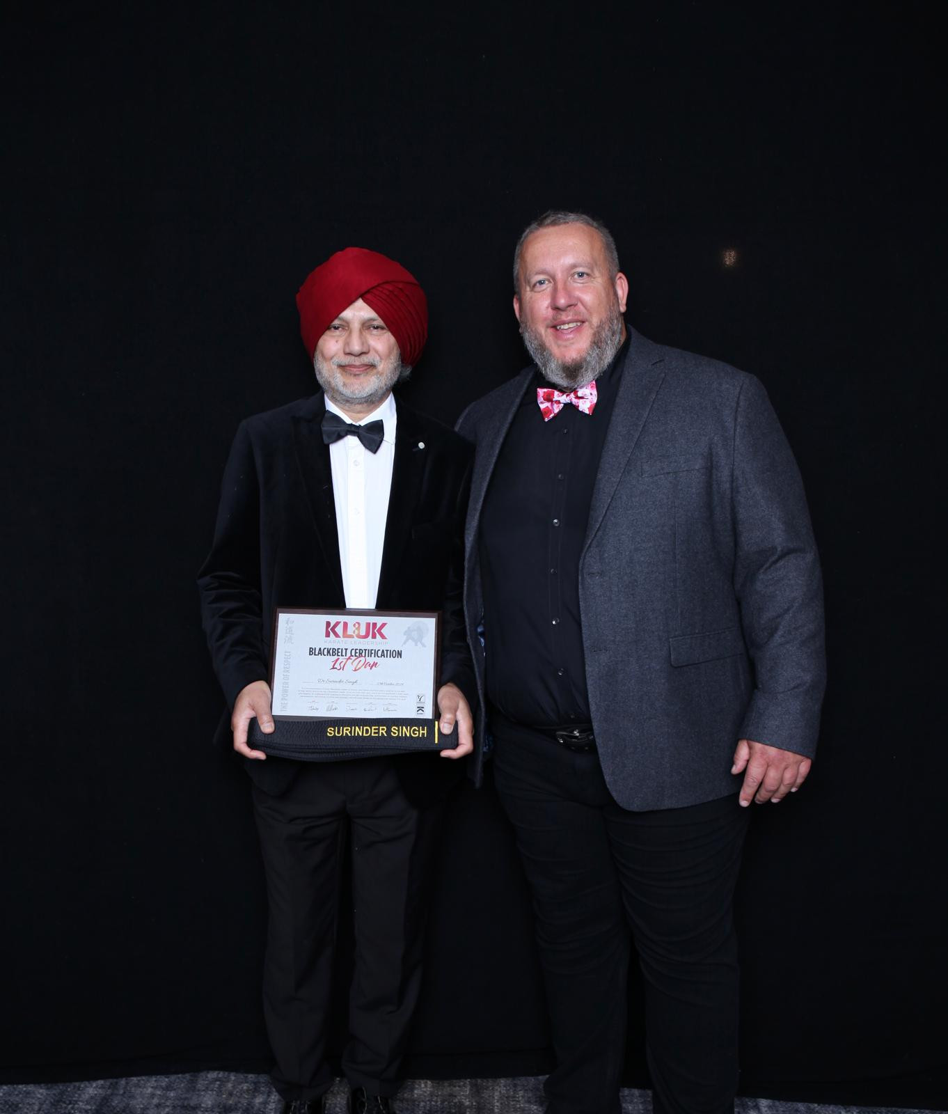 Surinder receives his belt and certificate