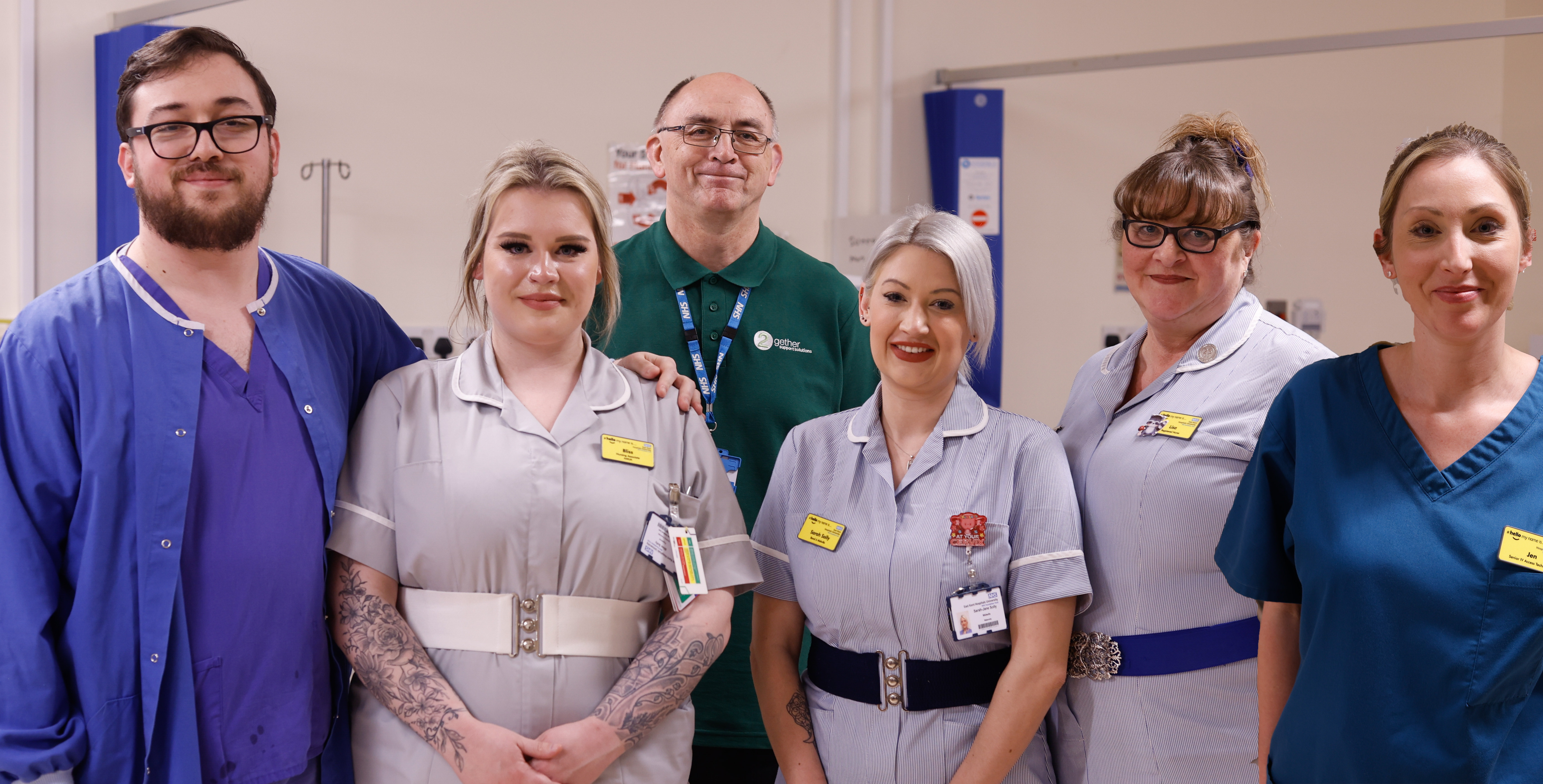 The Sollys and Poynters - group photo of six people in various clinical uniforms