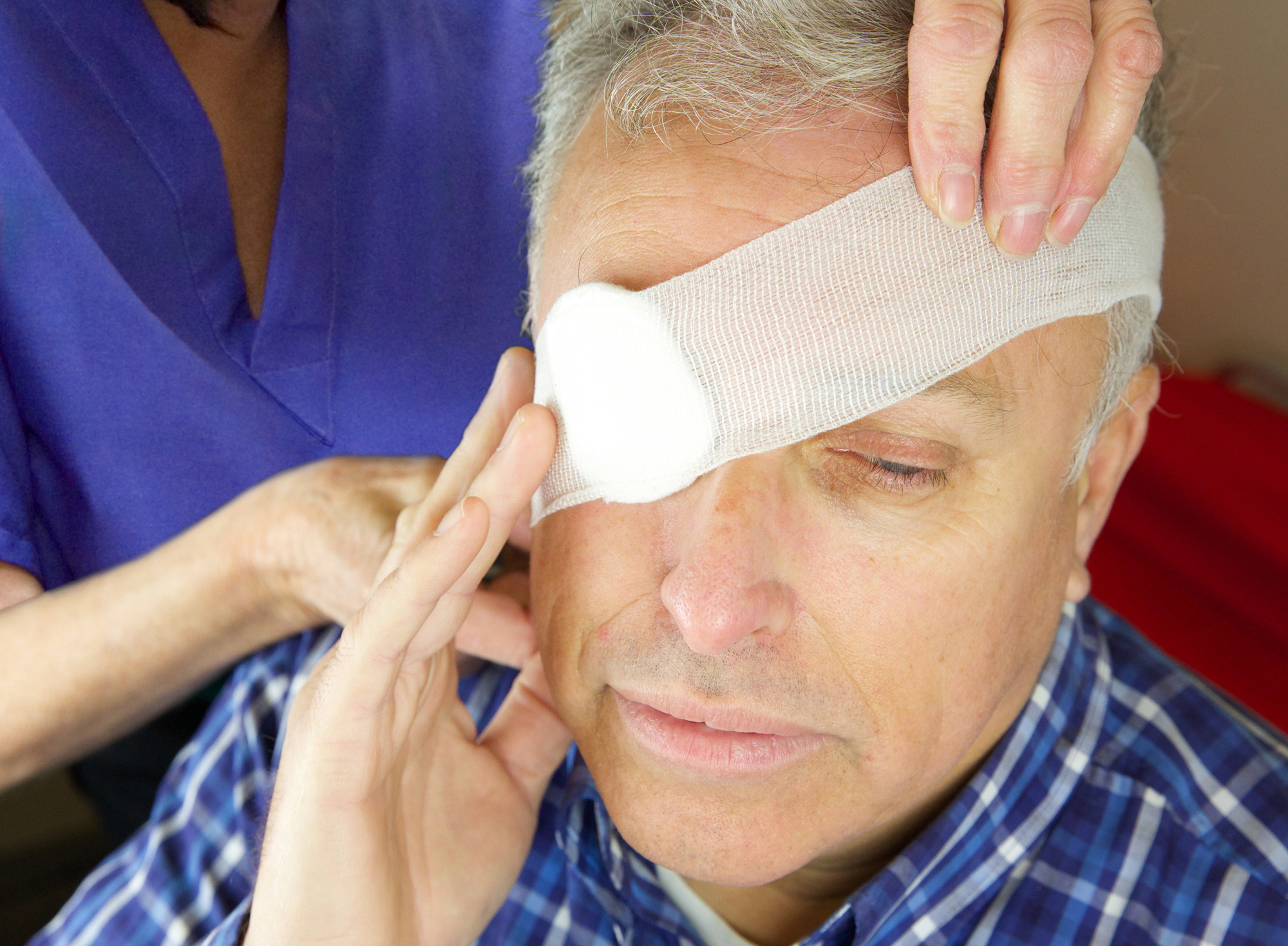 Man having his eye bandaged by a nurse
