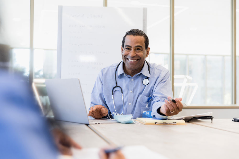 Doctor works at a laptop